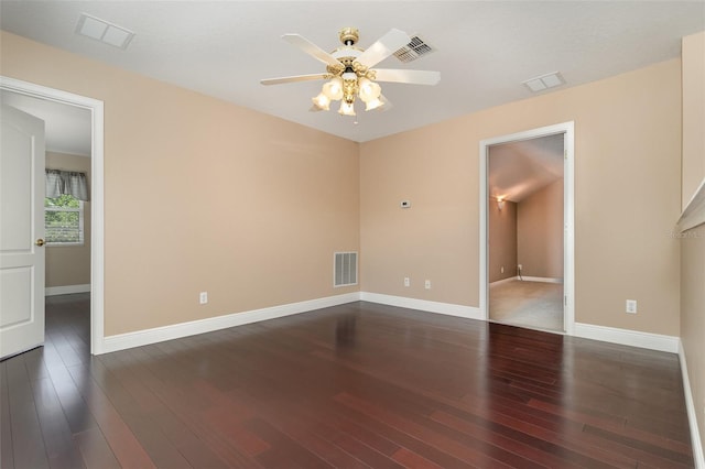 spare room featuring a ceiling fan, visible vents, and dark wood-style flooring