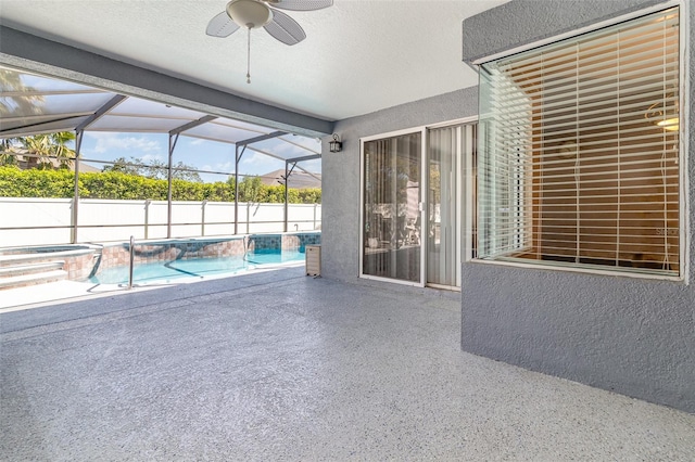 view of pool with a patio area, a jacuzzi, a lanai, and a ceiling fan