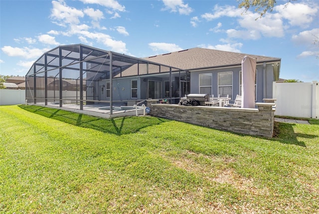 rear view of property featuring a patio, a yard, and fence