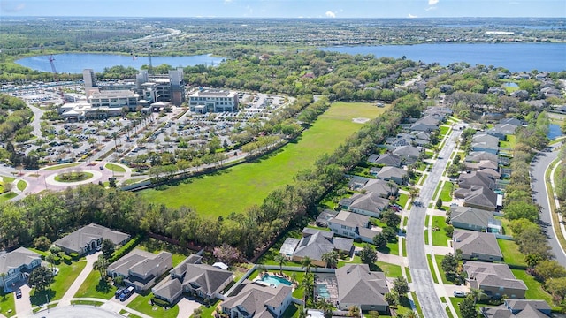 birds eye view of property with a residential view and a water view