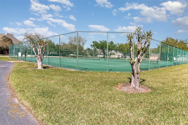 view of sport court featuring a lawn and fence