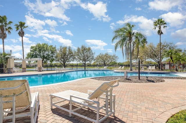 pool featuring a patio area and fence