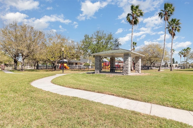 view of property's community with a gazebo, playground community, and a lawn