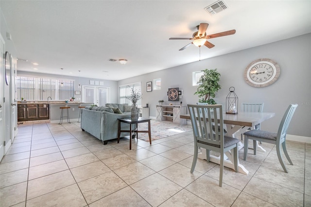 dining area featuring light tile patterned flooring, baseboards, and visible vents