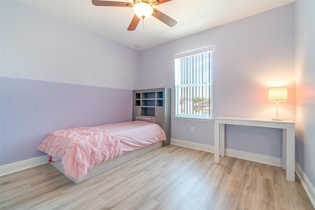 bedroom with baseboards, wood finished floors, and a ceiling fan