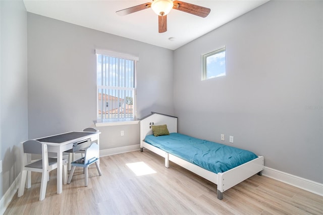 bedroom with baseboards, wood finished floors, and a ceiling fan