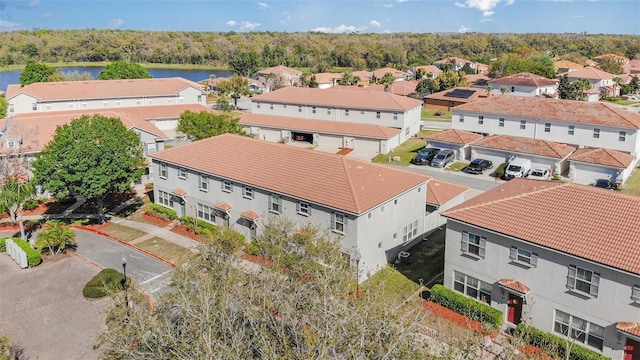 drone / aerial view with a residential view and a water view