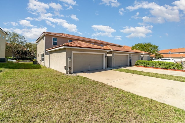 view of front of home with stucco siding, a tile roof, concrete driveway, a front yard, and a garage