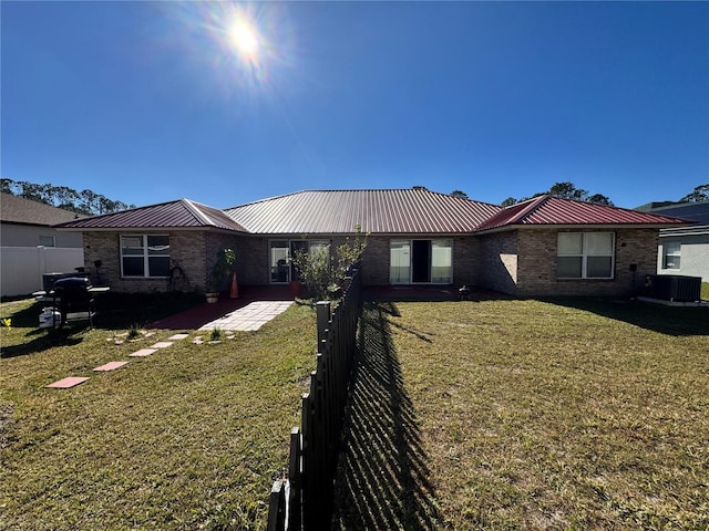 single story home featuring central AC, fence, a front yard, brick siding, and a patio area