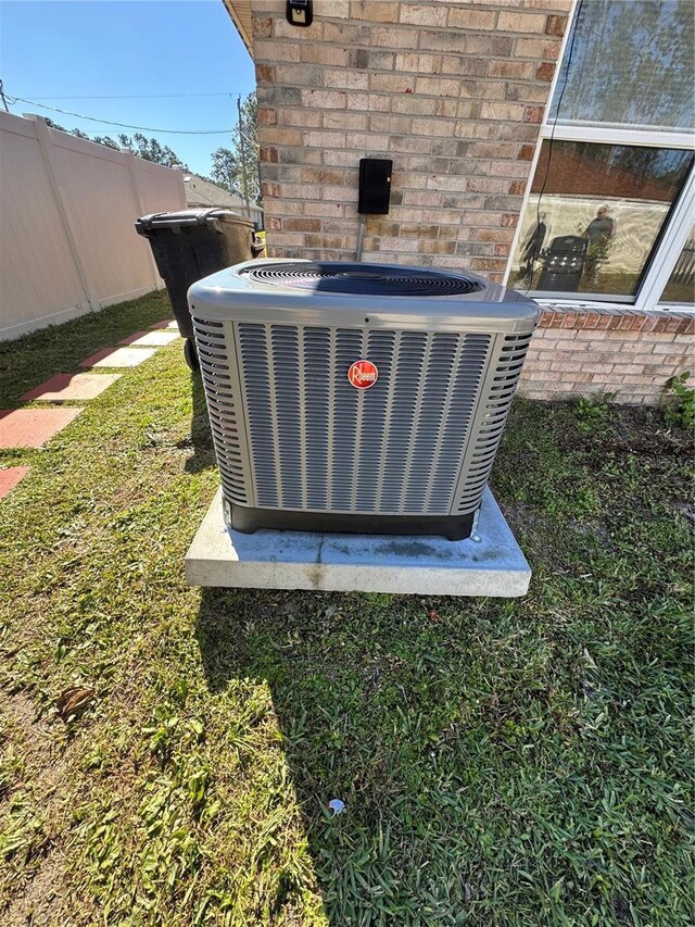 exterior details featuring central air condition unit and fence