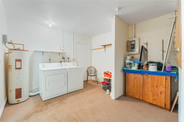 clothes washing area with washer and dryer, electric panel, concrete block wall, and electric water heater