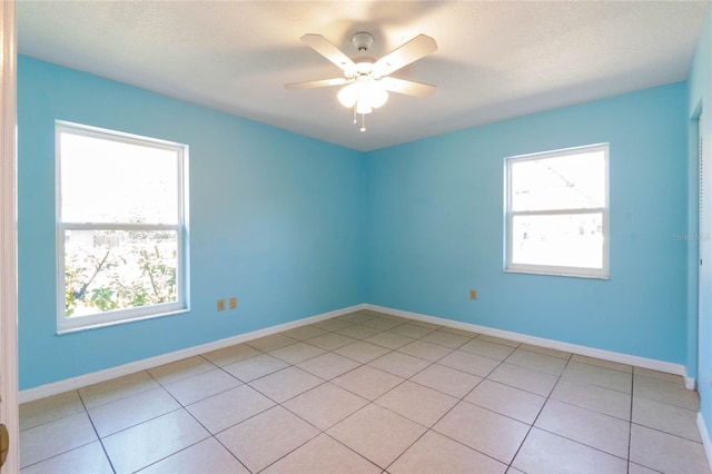 empty room with plenty of natural light, baseboards, and ceiling fan