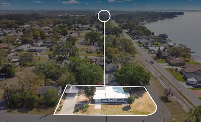 drone / aerial view with a residential view and a water view