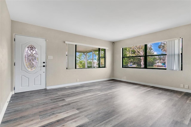 foyer featuring wood finished floors and baseboards