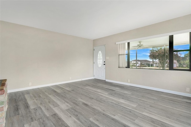 interior space featuring wood finished floors and baseboards