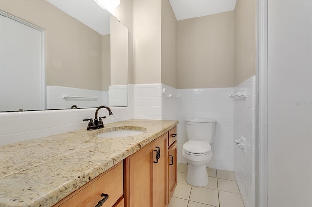 bathroom with tile patterned floors, a wainscoted wall, toilet, and vanity