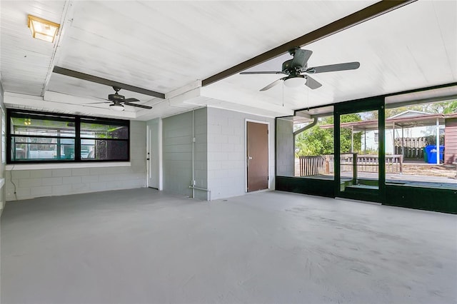 unfurnished sunroom featuring a ceiling fan