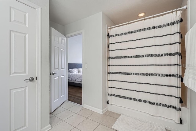bathroom featuring a shower with shower curtain, baseboards, recessed lighting, and tile patterned flooring