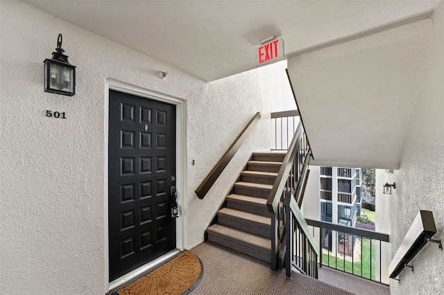 entrance to property with stucco siding