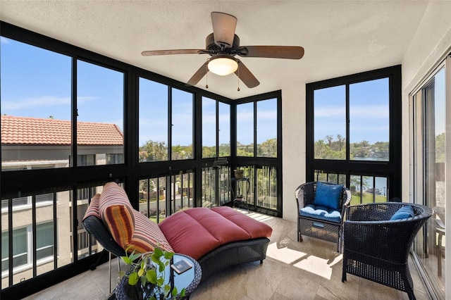 sunroom featuring a wealth of natural light and ceiling fan