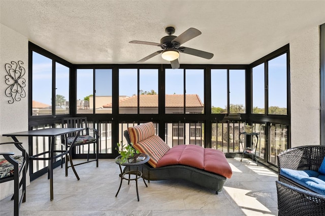 sunroom / solarium with a ceiling fan