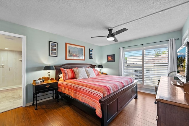 bedroom featuring a textured ceiling, ceiling fan, and wood-type flooring