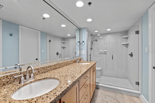 full bathroom featuring a sink, recessed lighting, a stall shower, and double vanity