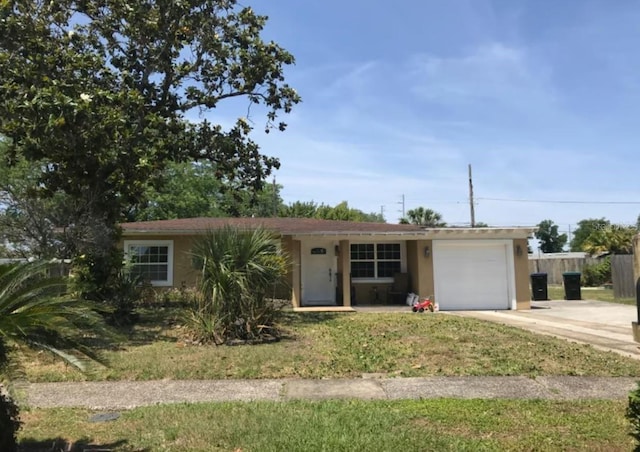 ranch-style house featuring an attached garage, fence, driveway, and stucco siding