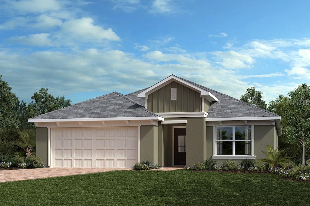 single story home with stucco siding, decorative driveway, board and batten siding, an attached garage, and a front yard