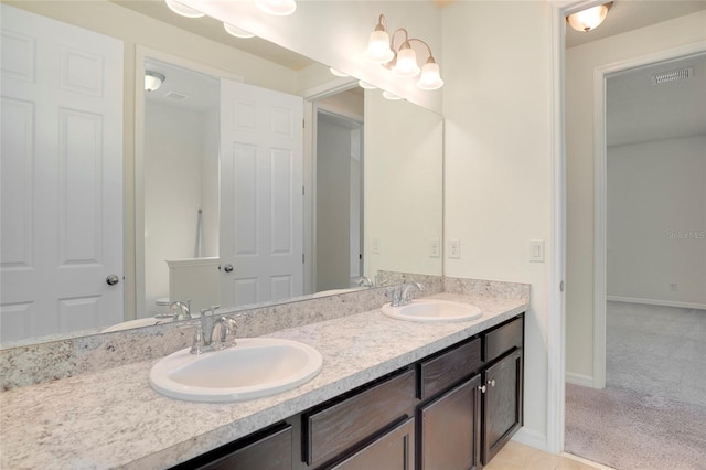 full bathroom featuring double vanity, baseboards, visible vents, and a sink