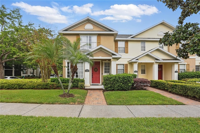 view of front of property with stucco siding and a front lawn