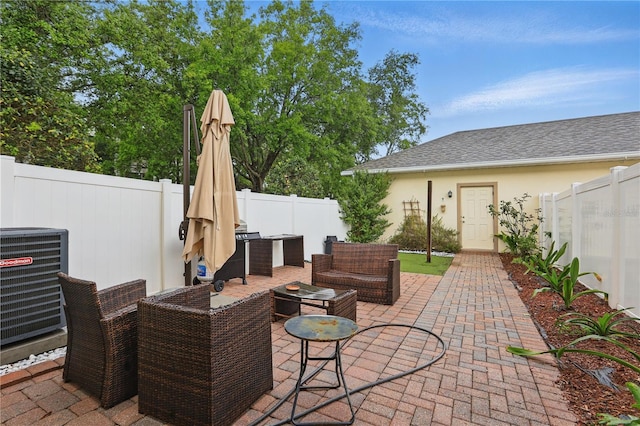 view of patio featuring an outdoor living space, central AC, and a fenced backyard