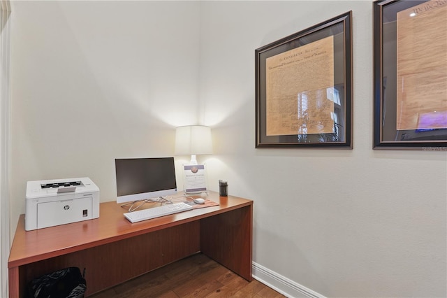 office area with baseboards and wood finished floors