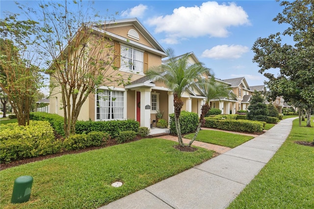 view of front of home featuring stucco siding and a front lawn