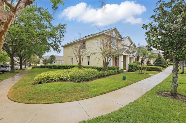 view of front of house with a front yard and stucco siding