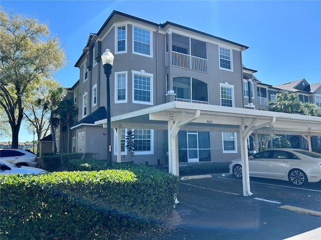 view of front of property featuring stucco siding and covered parking