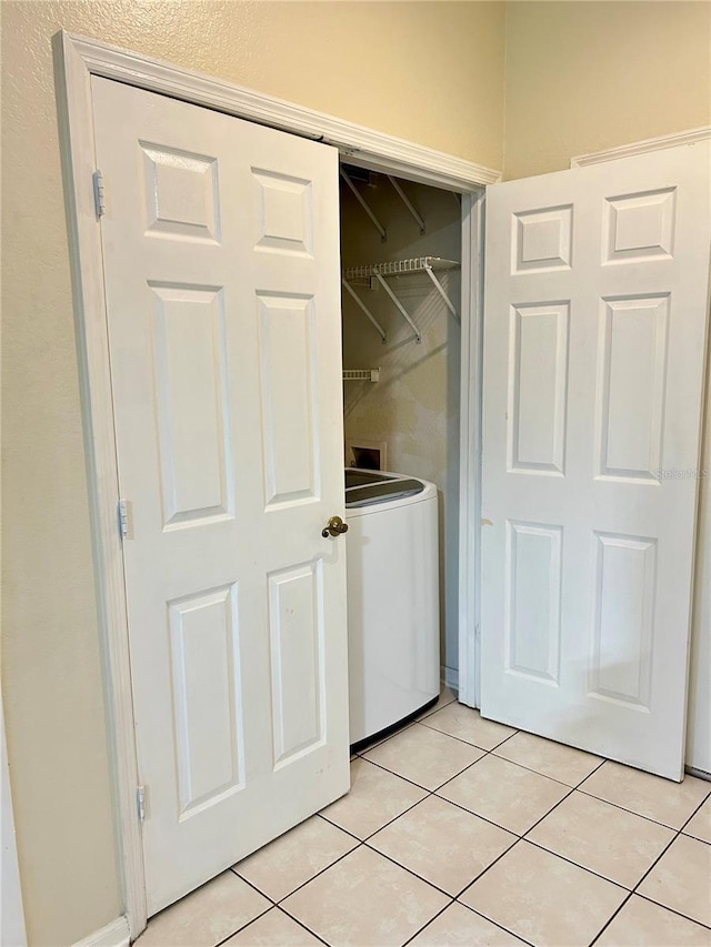 washroom featuring light tile patterned floors, laundry area, and washer / clothes dryer