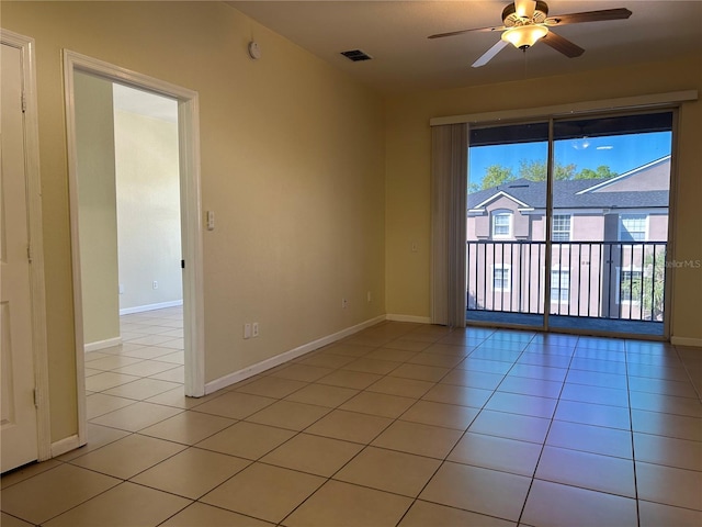 spare room with light tile patterned floors, visible vents, baseboards, and ceiling fan