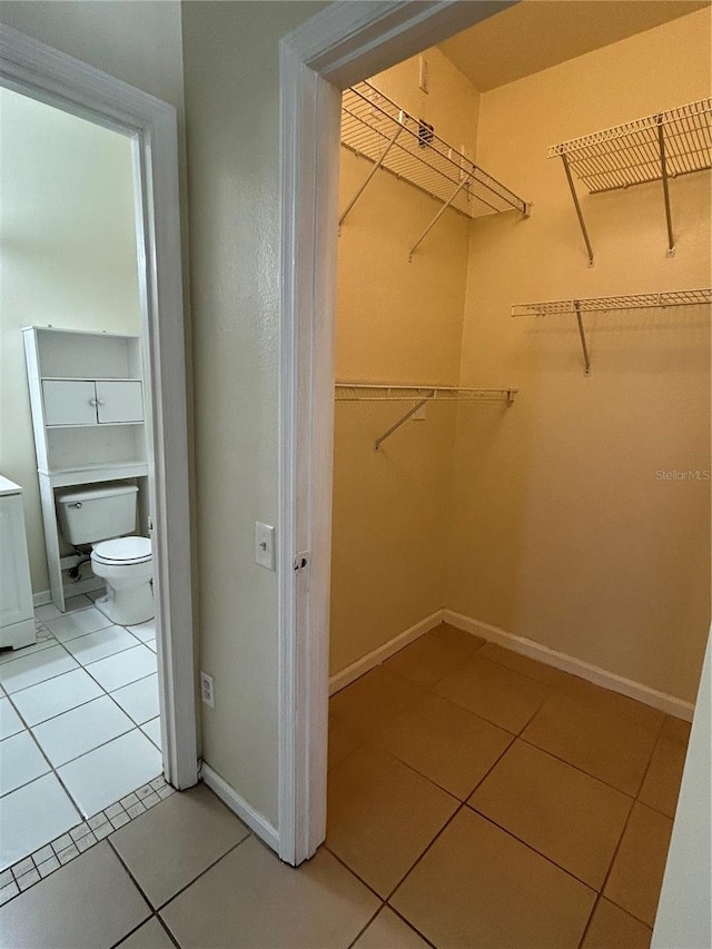 spacious closet with light tile patterned floors and washer / dryer