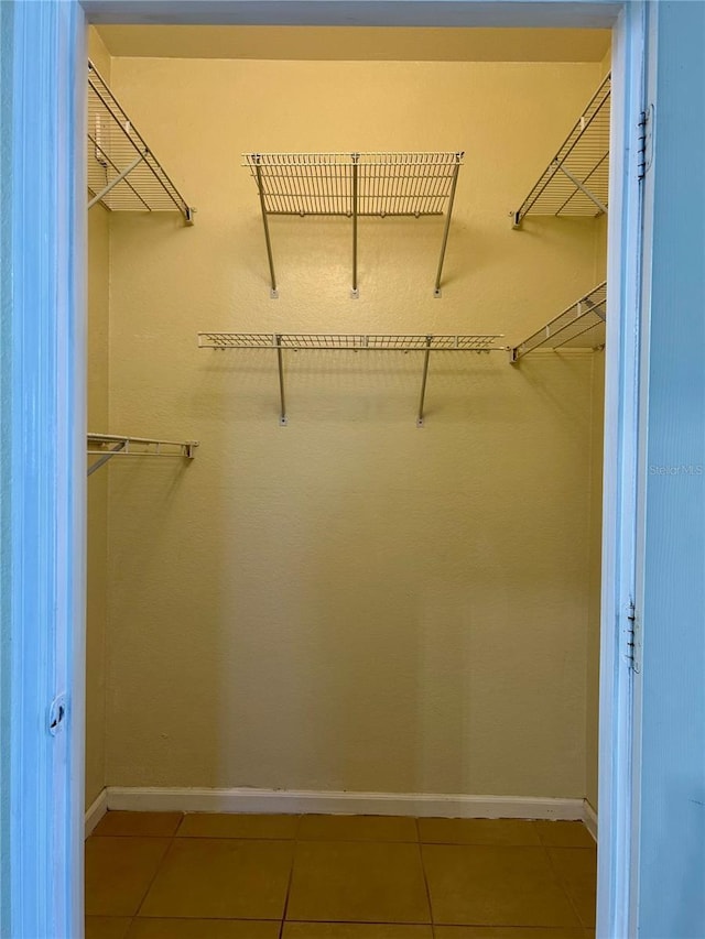 spacious closet with light tile patterned flooring