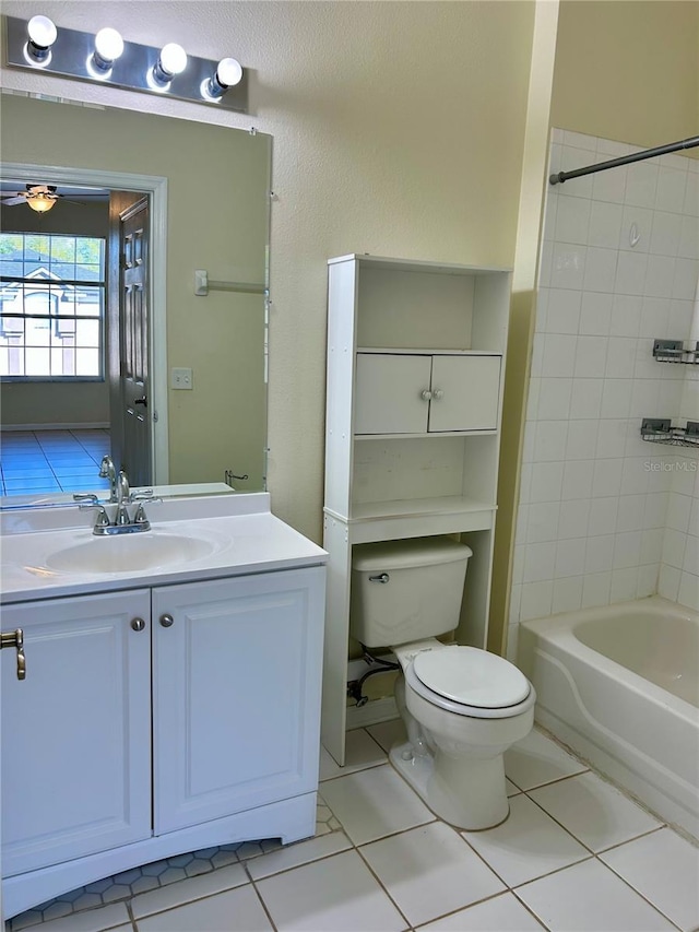 bathroom with vanity, ceiling fan, shower / washtub combination, tile patterned floors, and toilet