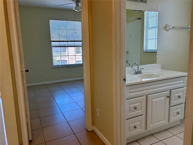 bathroom with vanity, tile patterned floors, a ceiling fan, and baseboards