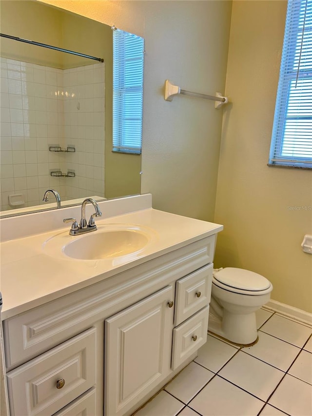 full bath featuring vanity, baseboards, a shower, tile patterned floors, and toilet