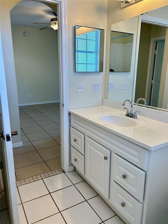 bathroom with tile patterned floors, baseboards, vanity, and a ceiling fan