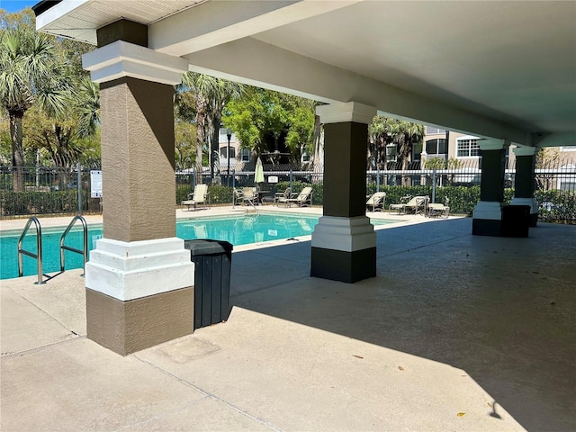 pool featuring a patio and fence