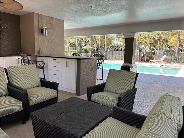 view of patio / terrace featuring a fenced in pool and fence