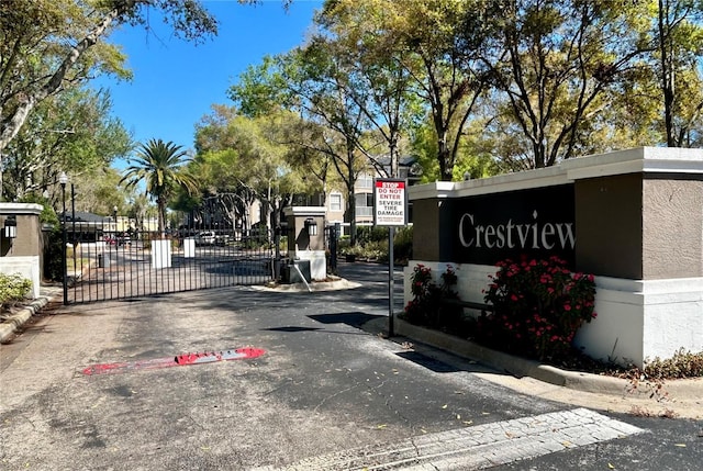 view of road with curbs, a gated entry, and a gate