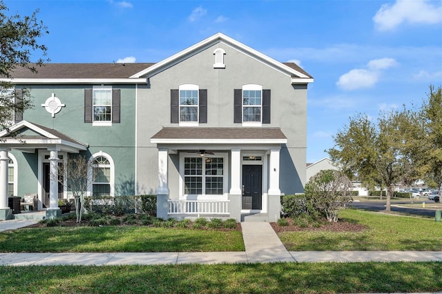 view of front facade featuring stucco siding, covered porch, and a front lawn