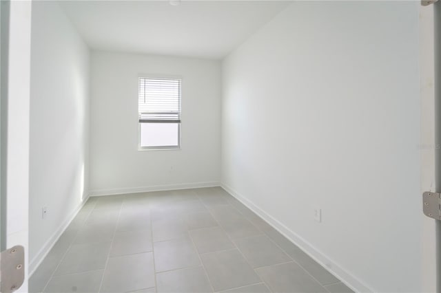 unfurnished room featuring baseboards