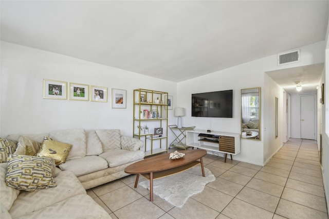 living room featuring light tile patterned floors and visible vents